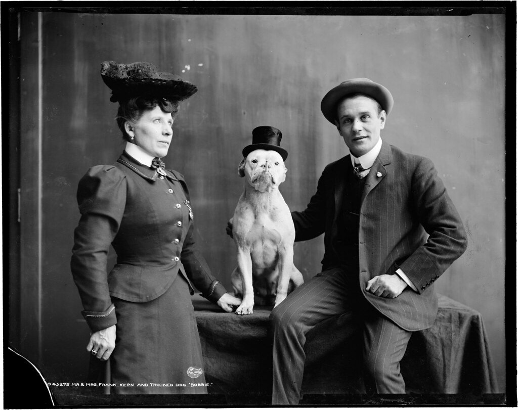 black and white photo of man, woman and dog